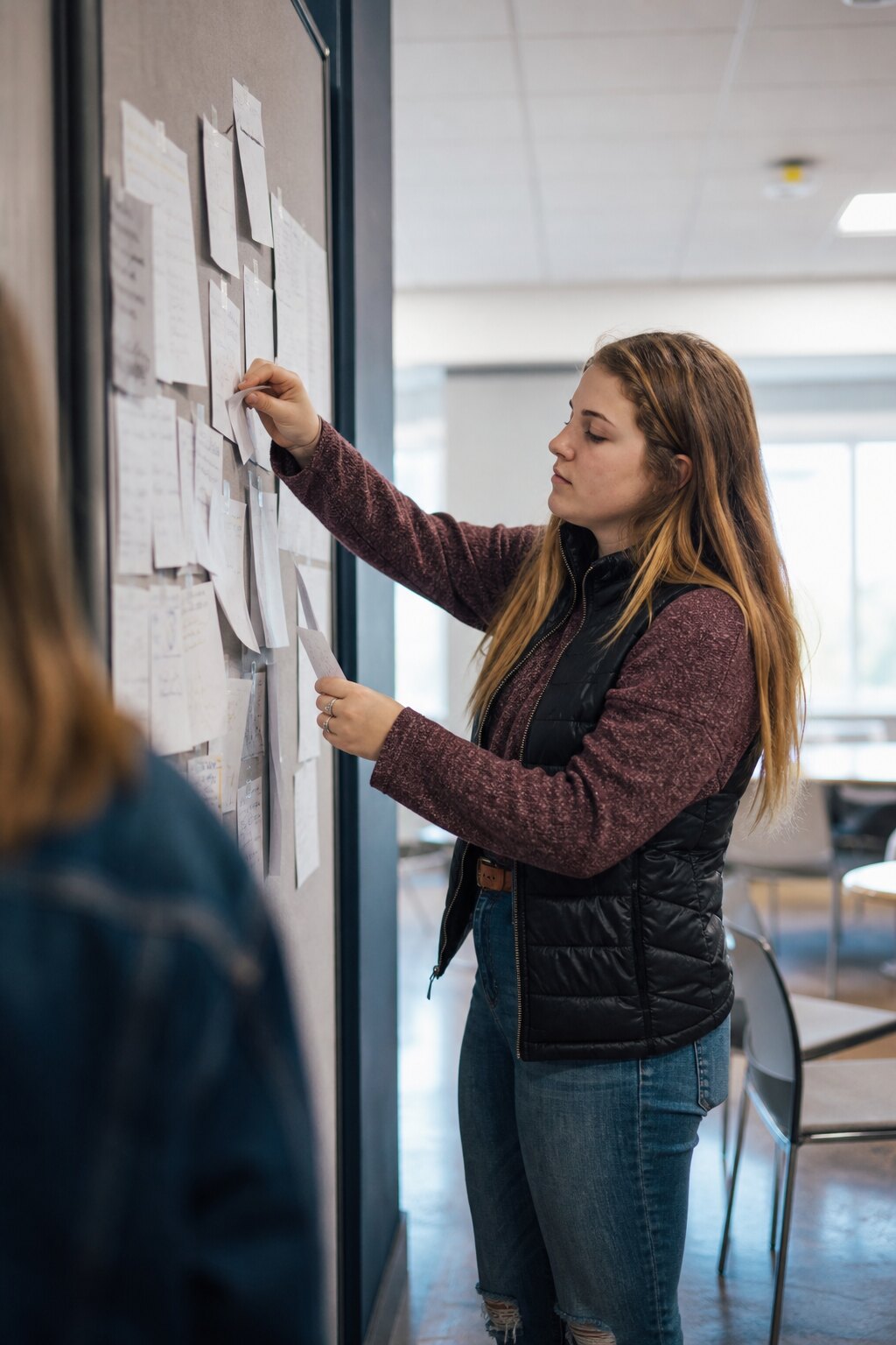 Young adult students working through problems on a whiteboard